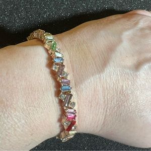 Rainbow-toned gorgeous gold tone faux stone stretch bracelet.
